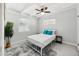 Bright bedroom features a ceiling fan, crisp white walls, and neutral-toned flooring at 2205 W Cambridge Ave, Phoenix, AZ 85009