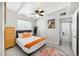 Comfortable bedroom with a ceiling fan, dresser, and colorful artwork at 2205 W Cambridge Ave, Phoenix, AZ 85009