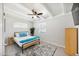 Sunlit bedroom boasts a ceiling fan and white-painted ceiling beams above neutral-toned flooring at 2205 W Cambridge Ave, Phoenix, AZ 85009