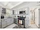 Modern kitchen featuring gray cabinets, stainless steel appliances, and granite countertops at 2205 W Cambridge Ave, Phoenix, AZ 85009