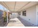 Covered outdoor patio features a white picket fence, neutral concrete flooring, and lush plants at 2205 W Cambridge Ave, Phoenix, AZ 85009