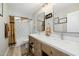 Farmhouse-style bathroom with double vanity, decorative mirrors, and shower-tub combo at 22222 N 54Th Way, Phoenix, AZ 85054