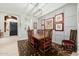 Beautiful dining room with a wooden table, chairs, wainscoting, and decorative artwork at 22222 N 54Th Way, Phoenix, AZ 85054