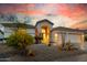 Beautiful single-story home with desert landscaping and a two-car garage at dusk at 22222 N 54Th Way, Phoenix, AZ 85054