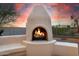 Outdoor fireplace feature with custom seating and desert landscaping at 22222 N 54Th Way, Phoenix, AZ 85054