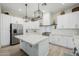 Bright kitchen featuring a central island with stainless steel appliances and modern white cabinets at 22222 N 54Th Way, Phoenix, AZ 85054