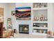 Living room area highlighting the fireplace and decorative shelving with the TV above it at 22222 N 54Th Way, Phoenix, AZ 85054