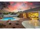 Backyard view with a gorgeous pool, stone accents, desert landscaping and covered patio at 22222 N 54Th Way, Phoenix, AZ 85054