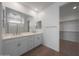 Bright bathroom with dual vanity, walk-in shower, and walk-in closet at 24192 W Agora Ln, Buckeye, AZ 85326