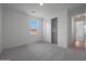 Bedroom with window, closet, neutral carpet, and paint at 24192 W Agora Ln, Buckeye, AZ 85326