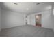 Bright bedroom with carpet, large windows, and ensuite bath at 24192 W Agora Ln, Buckeye, AZ 85326