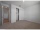 Carpeted bedroom with closet, windows, and neutral paint at 24192 W Agora Ln, Buckeye, AZ 85326