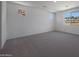 Bonus room featuring neutral carpet and multiple windows at 24192 W Agora Ln, Buckeye, AZ 85326