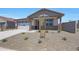 Charming single-story home with neutral tones, a two car garage and rock landscaping at 24192 W Agora Ln, Buckeye, AZ 85326