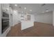 Bright, open kitchen featuring sleek white cabinetry and stainless steel appliances at 24192 W Agora Ln, Buckeye, AZ 85326