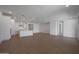 Spacious open-concept living area with wood-look floors leading to the kitchen at 24192 W Agora Ln, Buckeye, AZ 85326