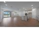 Spacious open-concept living area with wood-look floors and sliding glass doors to the backyard at 24192 W Agora Ln, Buckeye, AZ 85326