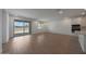 Bright living room with wood floors, sliding glass doors to the backyard, and modern design at 24192 W Agora Ln, Buckeye, AZ 85326