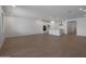 Spacious open-concept living area with wood-look floors leading to the kitchen at 24192 W Agora Ln, Buckeye, AZ 85326