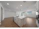 Spacious open-concept living area with wood-look floors leading to the kitchen at 24192 W Agora Ln, Buckeye, AZ 85326