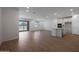 Spacious open-concept living area with wood-look floors and sliding glass doors to the backyard at 24192 W Agora Ln, Buckeye, AZ 85326