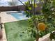 Backyard view showcasing a pool, waterfall feature, and low-maintenance artificial grass at 24478 N 166Th Ave, Surprise, AZ 85387