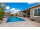 View of backyard featuring pool, travertine tile deck, landscaped areas and outdoor grill at 24478 N 166Th Ave, Surprise, AZ 85387