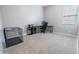 Bedroom featuring neutral carpet, an office desk, and a black wire pet crate at 24478 N 166Th Ave, Surprise, AZ 85387