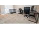 Bedroom featuring neutral carpet, an office desk, and a black wire pet crate at 24478 N 166Th Ave, Surprise, AZ 85387