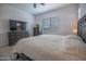 Comfortable bedroom featuring neutral colors, gray furniture, and a large window for plenty of natural light at 24478 N 166Th Ave, Surprise, AZ 85387