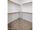 Walk-in closet features carpet flooring, multiple wooden rods for hanging clothes, and built in shelving at 24478 N 166Th Ave, Surprise, AZ 85387