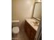 A quaint bathroom with a single sink, wood vanity, and tiled flooring at 2549 W Rose Ln # A223, Phoenix, AZ 85017