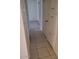 Hallway with tiled floors and ample closet space, leading to carpeted bedroom at 2549 W Rose Ln # A223, Phoenix, AZ 85017