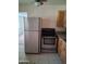 Bright kitchen with stainless steel appliances, granite countertops, and tile flooring at 2549 W Rose Ln # A223, Phoenix, AZ 85017