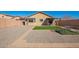 Spacious backyard with artificial turf, patio seating, and rock landscaping at 25797 W St Charles Ct, Buckeye, AZ 85326