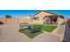 Backyard featuring an artificial turf area, covered patio, and gravel at 25797 W St Charles Ct, Buckeye, AZ 85326