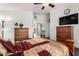 Well-lit bedroom with hardwood floors and modern ceiling fan offers plenty of closet space at 25797 W St Charles Ct, Buckeye, AZ 85326