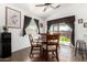 Bright dining area with a round wooden table, tile flooring, and a sliding glass door to the patio at 25797 W St Charles Ct, Buckeye, AZ 85326