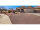 Single-story home featuring low-maintenance landscaping with desert rock and a cozy front porch at 25797 W St Charles Ct, Buckeye, AZ 85326