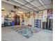 Organized garage with overhead storage, tool bench, and a colorful rug at 25797 W St Charles Ct, Buckeye, AZ 85326