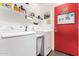 Functional laundry room with washer, dryer, and ample shelving space at 25797 W St Charles Ct, Buckeye, AZ 85326