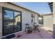 Back patio perfect for enjoying relaxing moments outside with chairs and an outdoor dining table at 2719 N Greenfield Rd, Phoenix, AZ 85006