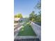 A putting green in the backyard with putting clubs along the brick wall at 2719 N Greenfield Rd, Phoenix, AZ 85006