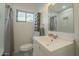 Bright bathroom with a stylish sink and towel rack plus a subway tile shower with black and white tiled floor at 2719 N Greenfield Rd, Phoenix, AZ 85006