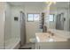 Bright bathroom with a shower and tub combination and a classic black and white tiled floor at 2719 N Greenfield Rd, Phoenix, AZ 85006