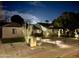 Charming home featuring manicured landscaping and an inviting walkway with accent lighting at nighttime at 2719 N Greenfield Rd, Phoenix, AZ 85006