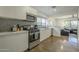 Well-lit kitchen with modern appliances, white cabinets, and an open layout at 2719 N Greenfield Rd, Phoenix, AZ 85006