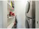 Functional laundry room with washer and dryer, plus shelving for efficient storage solutions at 2719 N Greenfield Rd, Phoenix, AZ 85006