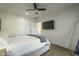 Main bedroom with ceiling fan, a wall-mounted television, natural light, and painted concrete floor at 2719 N Greenfield Rd, Phoenix, AZ 85006