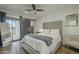 Main bedroom with sliding barn door to outside, ceiling fan, and painted concrete floor at 2719 N Greenfield Rd, Phoenix, AZ 85006